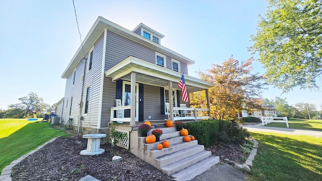 view of front of home featuring a front lawn and covered porch