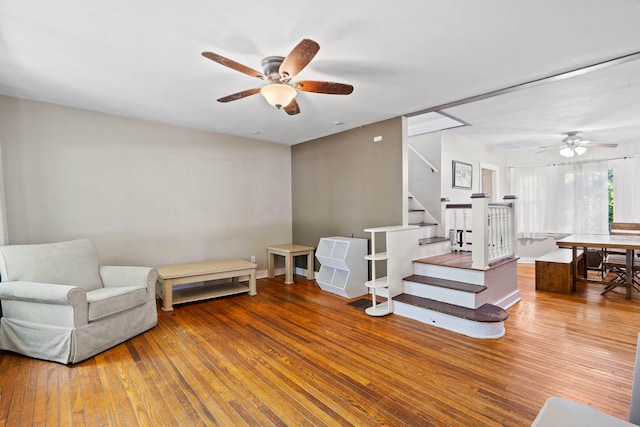 sitting room with wood-type flooring and ceiling fan