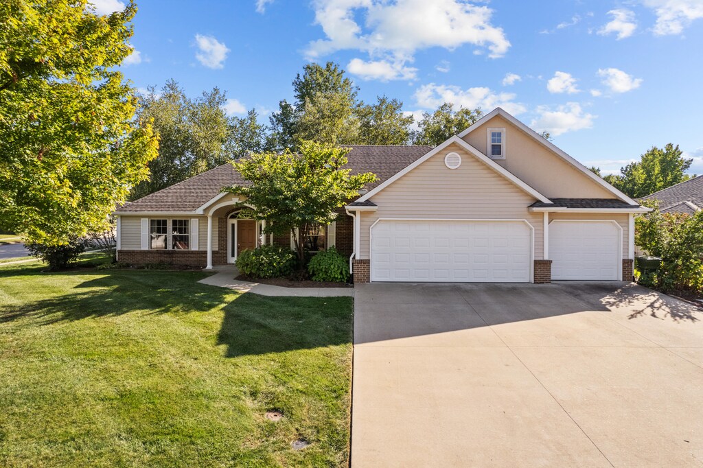 view of front of home featuring a garage and a front lawn