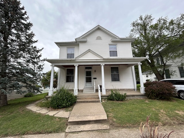 view of front of home with a front yard and a porch