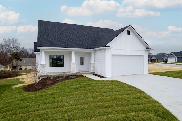 view of front of house featuring a garage, covered porch, and a front yard