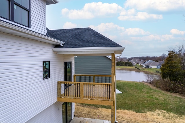 wooden deck with a yard and a water view