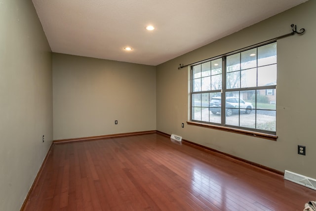 empty room with hardwood / wood-style floors