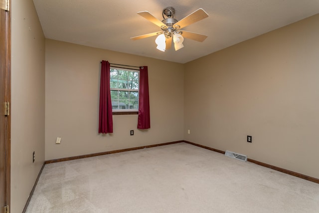 spare room featuring ceiling fan, a textured ceiling, and light colored carpet