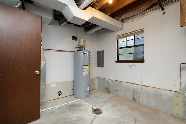 basement featuring electric water heater and electric panel