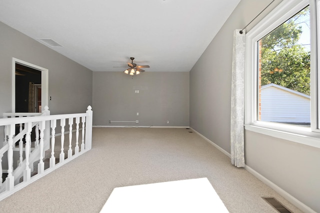 carpeted empty room featuring ceiling fan