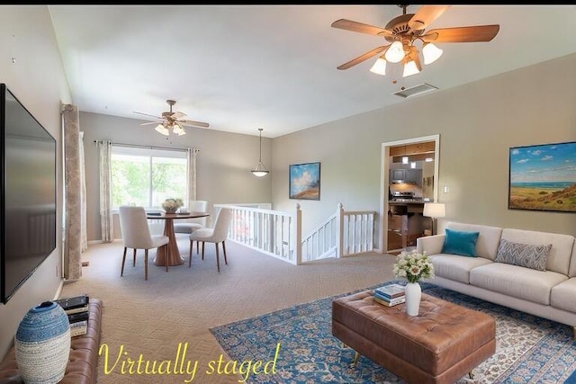 carpeted living room featuring ceiling fan