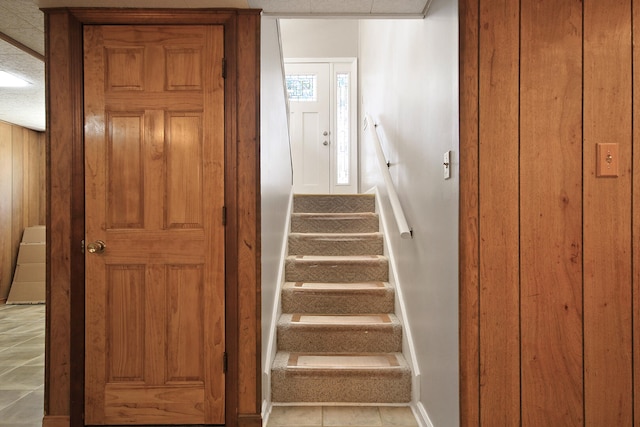 staircase with tile patterned floors