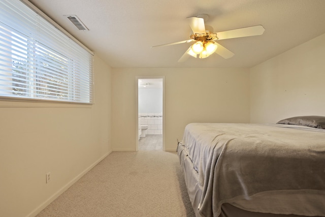 carpeted bedroom with connected bathroom and ceiling fan