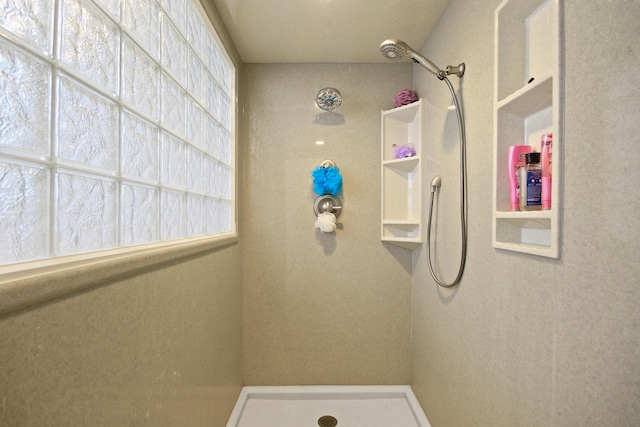 bathroom featuring plenty of natural light and walk in shower