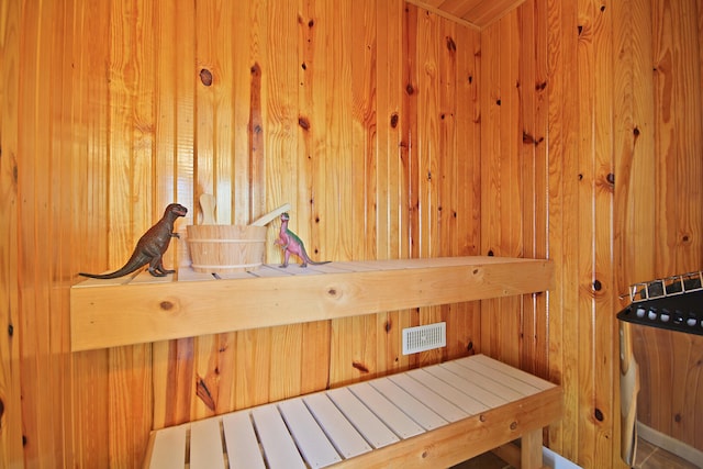 view of sauna with wooden walls