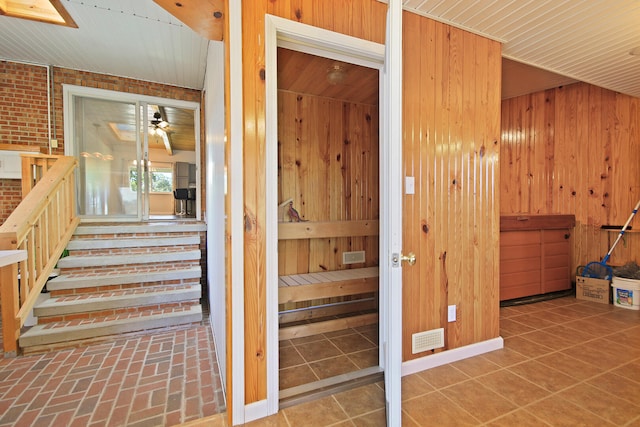 interior space with brick wall and wooden walls