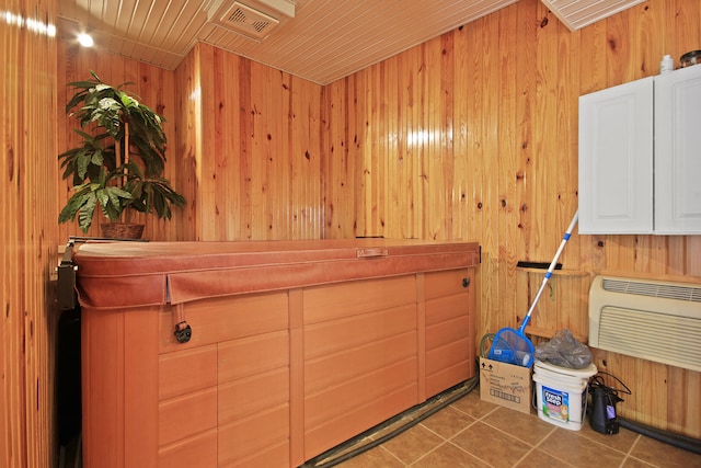 misc room with wood walls, wood ceiling, and tile patterned flooring