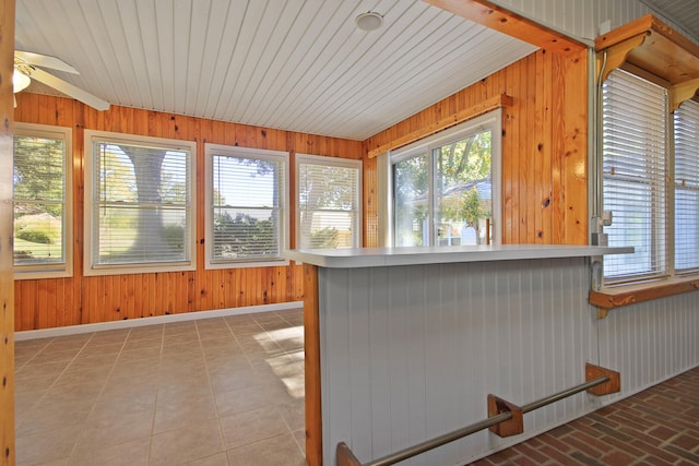 unfurnished sunroom featuring ceiling fan, a hot tub, and wooden ceiling