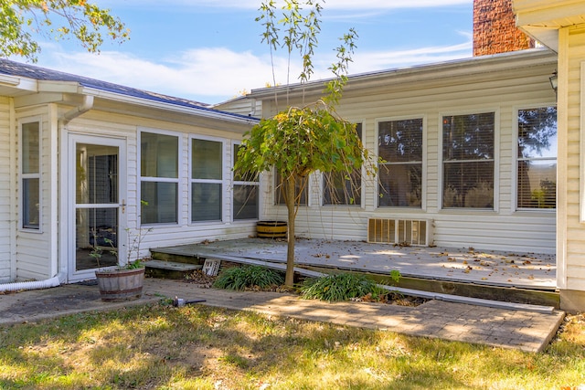 entrance to property with a deck