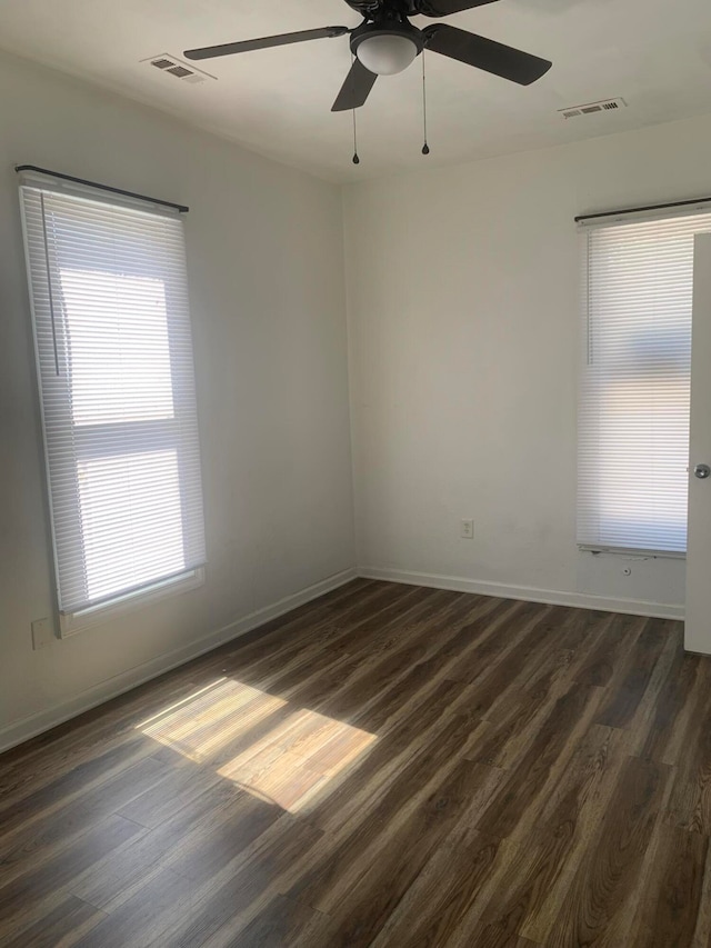 spare room with ceiling fan and dark hardwood / wood-style floors