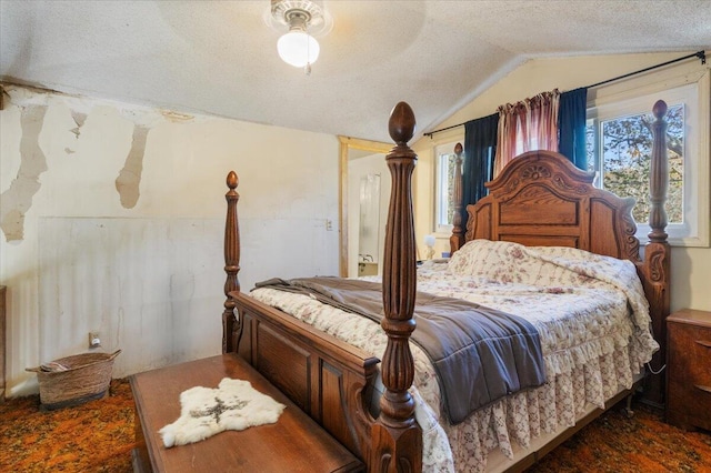 bedroom with a textured ceiling, ceiling fan, and lofted ceiling