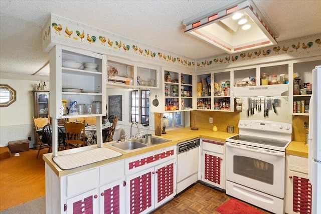 kitchen with white appliances, white cabinets, dark parquet floors, sink, and a textured ceiling