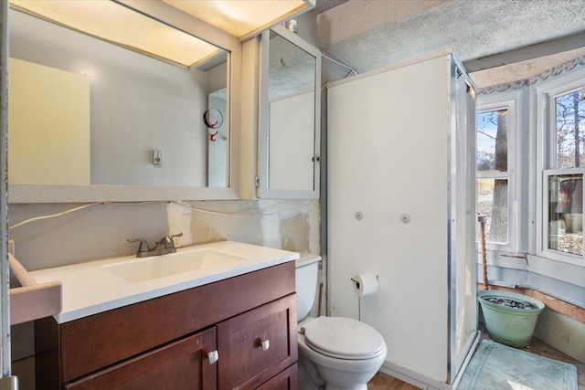 bathroom featuring a textured ceiling, vanity, toilet, and backsplash