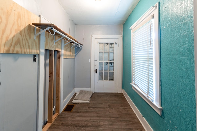 entryway with dark hardwood / wood-style flooring