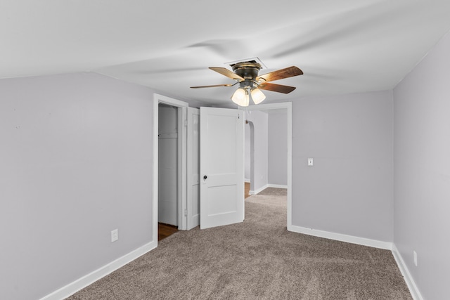 unfurnished bedroom featuring ceiling fan, a closet, and carpet flooring