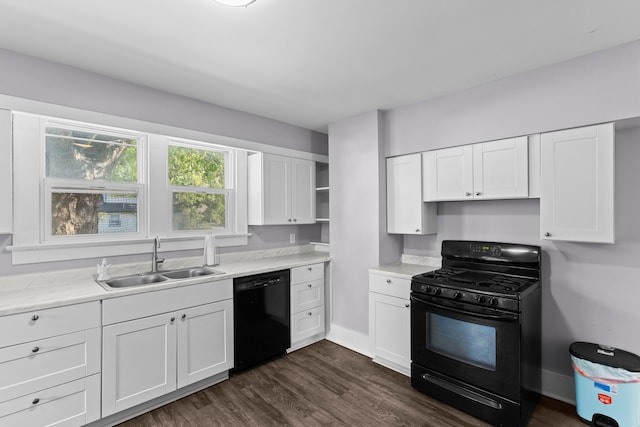 kitchen with black appliances, white cabinetry, and sink