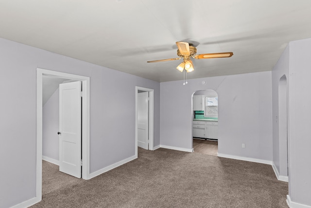 spare room featuring ceiling fan and carpet flooring