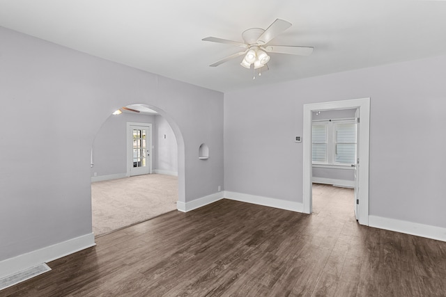 empty room with ceiling fan and dark hardwood / wood-style floors