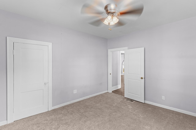 unfurnished room with ceiling fan and light colored carpet