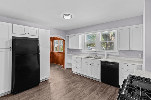 kitchen featuring dark wood-type flooring, black appliances, sink, and white cabinetry