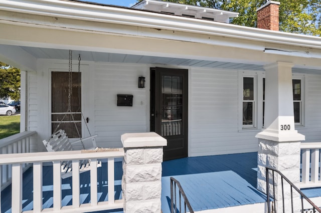 property entrance featuring covered porch