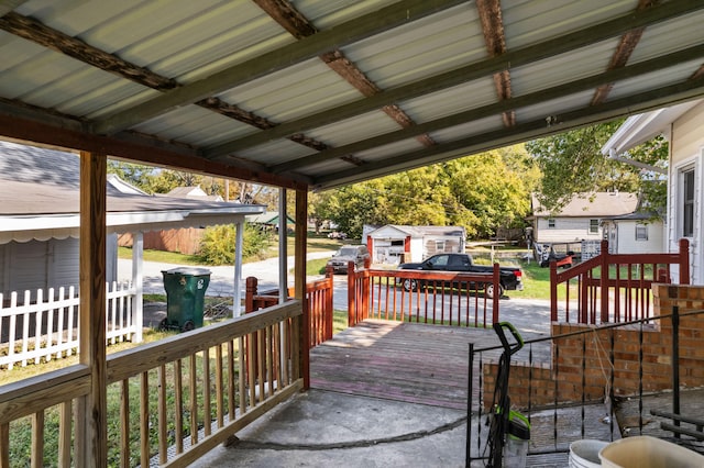 wooden terrace featuring a storage unit