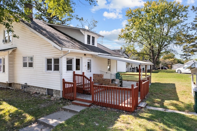 view of front of property with a front yard and a deck