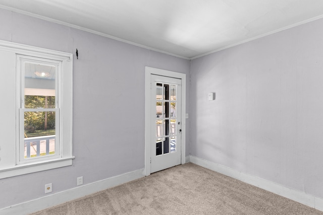 unfurnished room featuring ornamental molding and light colored carpet