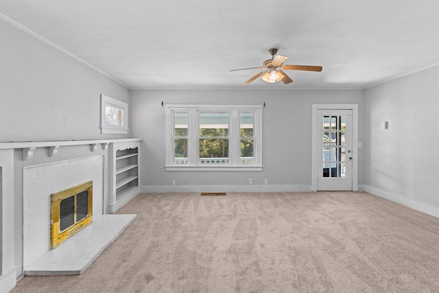 unfurnished living room with a brick fireplace, light carpet, and a healthy amount of sunlight