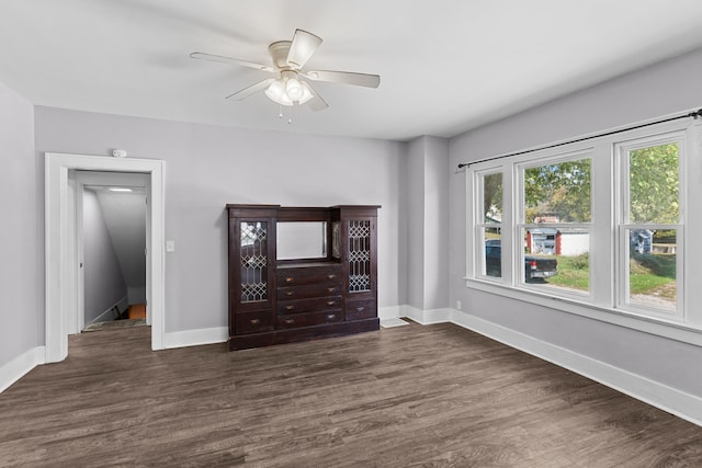 unfurnished bedroom featuring dark hardwood / wood-style floors and ceiling fan