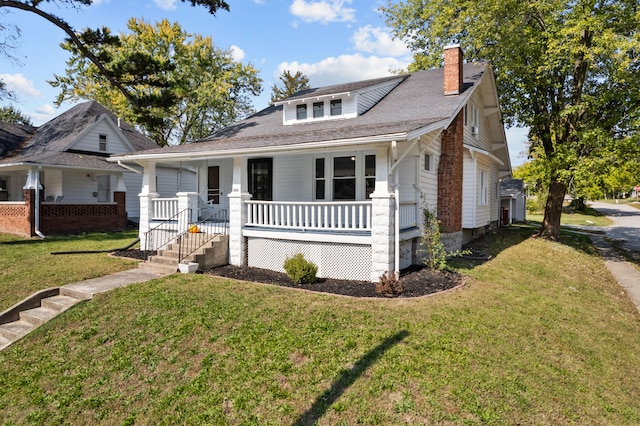 bungalow-style house featuring a porch and a front lawn