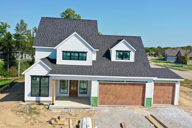 view of front of house with a porch and a garage