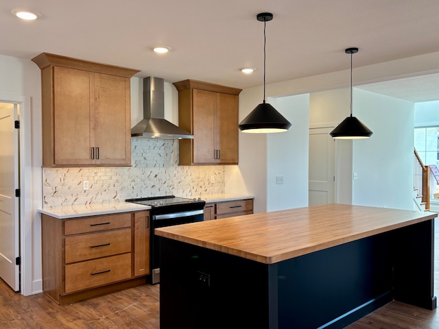 kitchen featuring wooden counters, electric range oven, wall chimney exhaust hood, dark wood finished floors, and decorative light fixtures