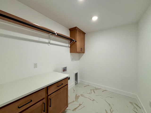 clothes washing area featuring hookup for an electric dryer, washer hookup, baseboards, marble finish floor, and cabinet space