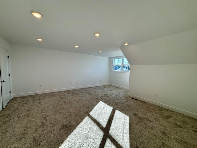 additional living space featuring carpet, lofted ceiling, baseboards, and recessed lighting