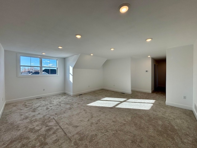 additional living space featuring vaulted ceiling, carpet floors, recessed lighting, and baseboards