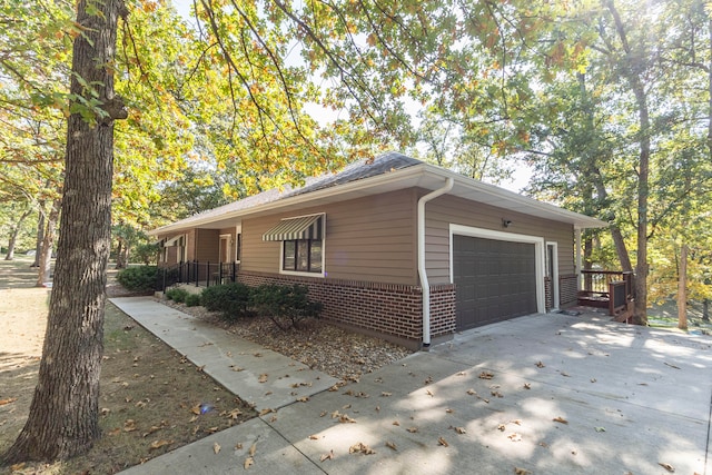 view of side of home featuring a garage