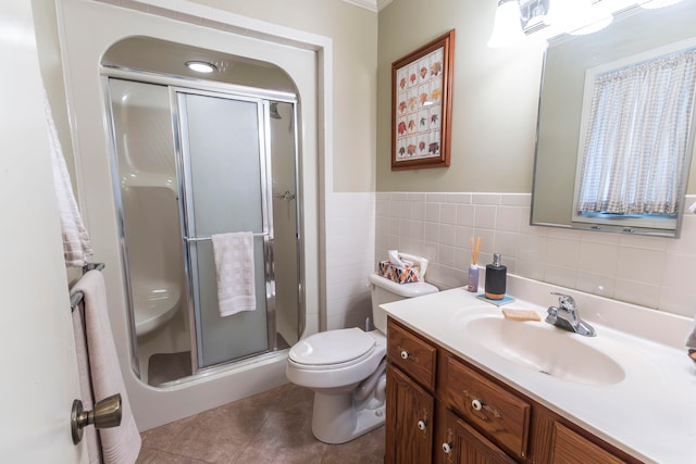 bathroom with vanity, tile patterned flooring, toilet, and an enclosed shower