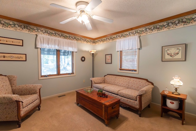 carpeted living room featuring ornamental molding, a textured ceiling, and ceiling fan