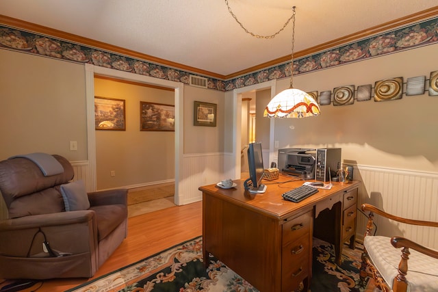 office with radiator heating unit, crown molding, and light wood-type flooring