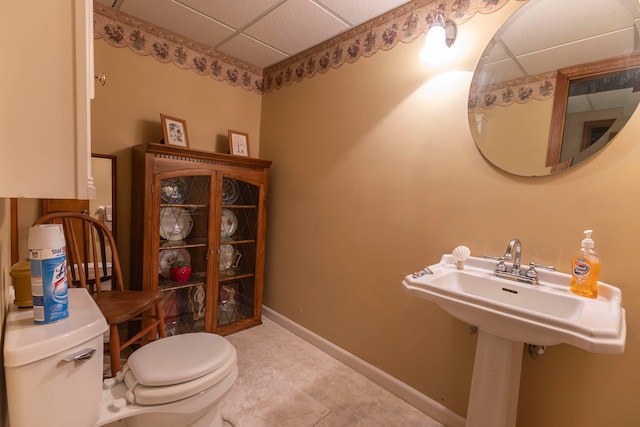 bathroom with a drop ceiling and toilet