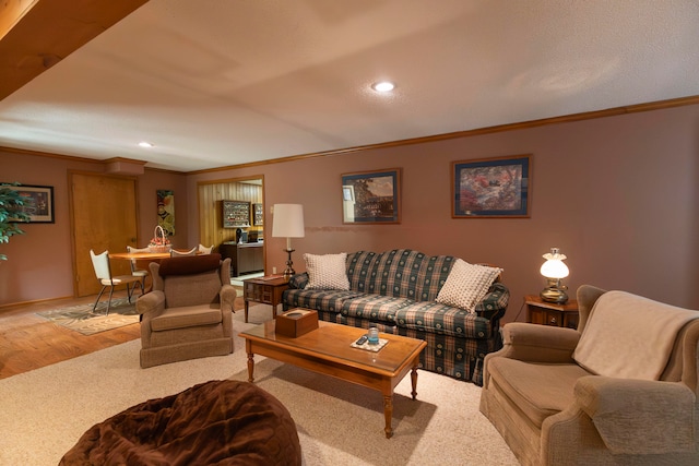 living room with crown molding and light hardwood / wood-style floors