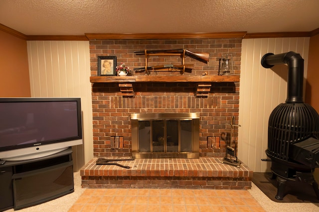 living room featuring ornamental molding, wooden walls, and a textured ceiling