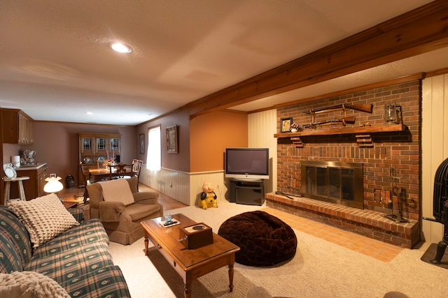 carpeted living room featuring ornamental molding, a brick fireplace, wooden walls, and a textured ceiling